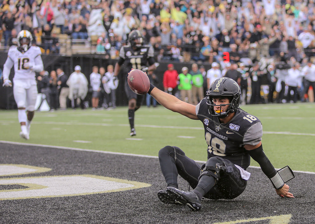 Vanderbilt quarterback Mo Hasan raises the ball in the end zone